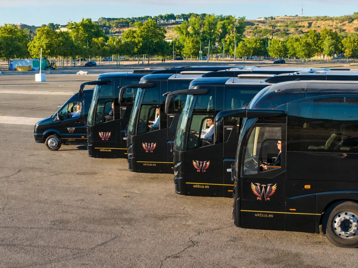 Flota de autocares y microbús de Winking Bus en formación con conductores al volante